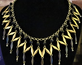 A striking vintage bib necklace in black and gold metal with French Jet accents