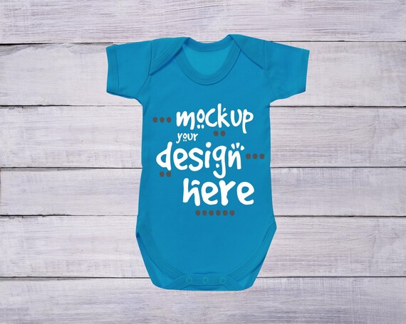 Bodysuit Mockup Sapphire Blue Bodysuit On White Wood Baby