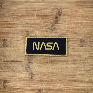 Vintage NASA Worm Patch 4.25x2 Gold Logo Black Space Program Memorabilia