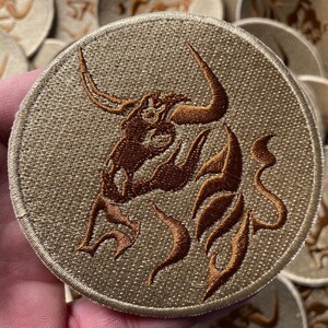 Taurus Astrology Sign Horoscope Iron On Patch, 3.5 Inches, held in a hand, offering a perspective on its size and how it looks in a real-world setting.