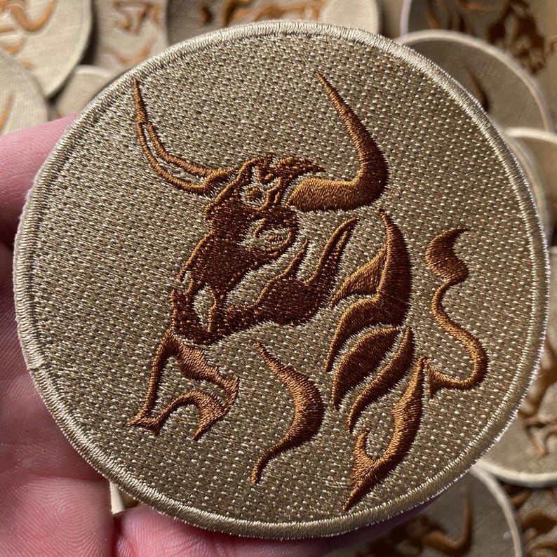 Taurus Astrology Sign Horoscope Iron On Patch, 3.5 Inches, held in a hand, offering a perspective on its size and how it looks in a real-world setting.
