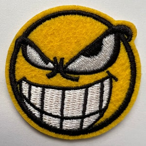 Mischievous Grinning Face Embroidered Patch Yellow Round Iron-On 1.75 Inches