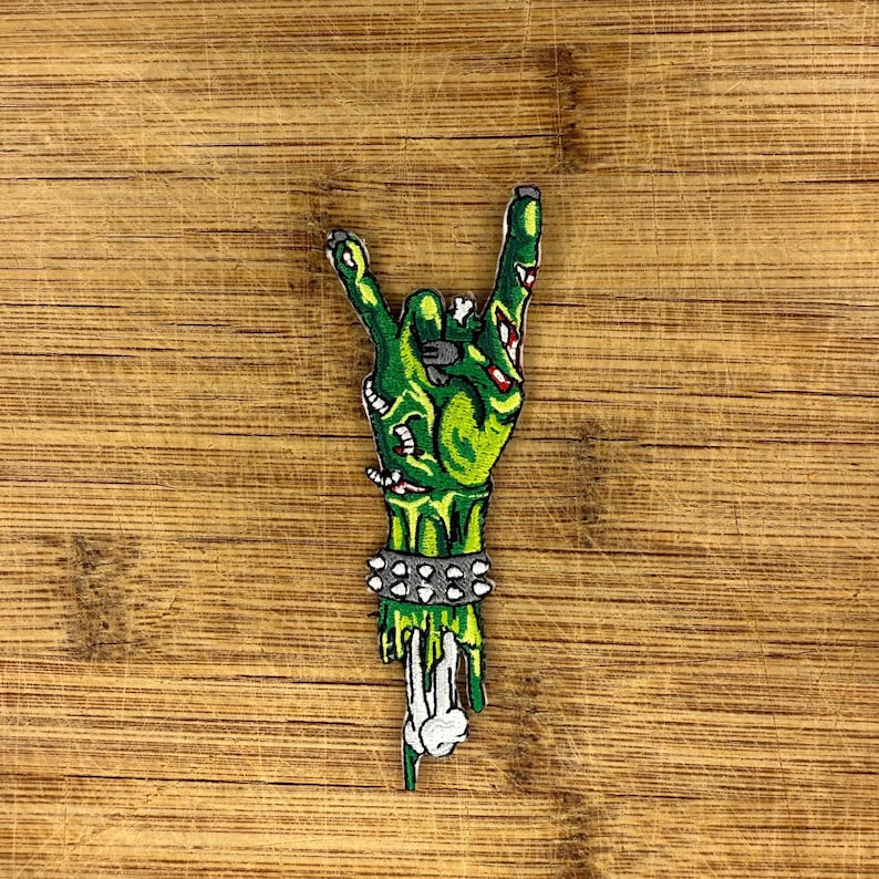 Punk zombie hand patch with green undead metal horns design for horror jackets, battle vests, and backpacks.