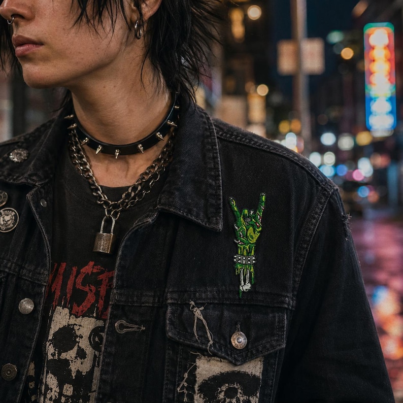 Zombie rock hand embroidered patch attached to a black punk denim vest in a nighttime urban scene.