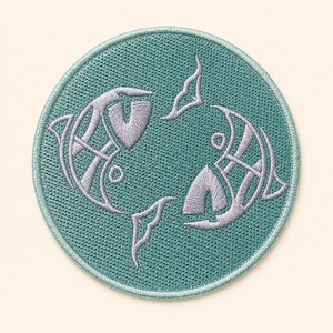 May include: A circular embroidered patch featuring a teal background with two stylized fish silhouettes stitched in light lavender thread. The fish are arranged in a circular formation, facing opposite directions, with visible embroidery texture.