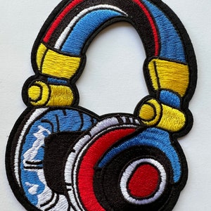 May include: A colourful embroidered patch of a pair of headphones. The headphones are black with blue, red, yellow, and white accents.