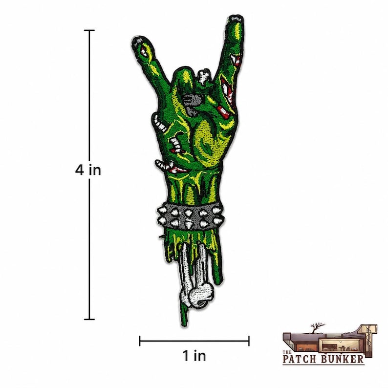 Zombie hand embroidered patch size reference graphic showing a green monster hand making a rock gesture, with studded bracelet, exposed bone, black measurement lines, and Patch Bunker logo on a clean white background.