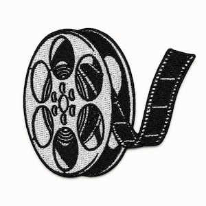 Black and white embroidered film reel patch with film strip detail centered on a square white background.