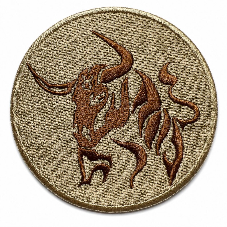 Round tan embroidered Taurus zodiac patch with a brown bull sign logo centered on a square white background.