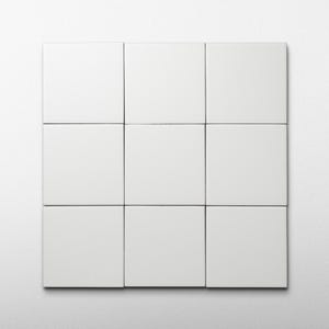 May include: Nine white square tiles arranged in a 3x3 grid. The tiles have a smooth, matte finish and are evenly spaced with thin black lines separating them. The background is a plain white wall.