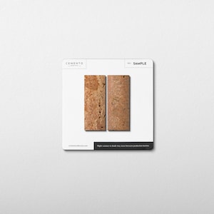 May include: Two rectangular cork samples with a natural, textured appearance are displayed on a white background. The samples are side-by-side, showcasing variations in color and grain. The word "SAMPLE" is printed on the top right corner.