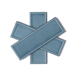 May include: Three blue ceramic tiles with a beveled edge, arranged in a star shape.