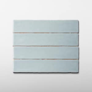 May include: Four rectangular, light blue ceramic tiles arranged horizontally. The tiles have a slightly textured surface and a visible brown edge. The tiles are stacked on top of each other, with a white background.