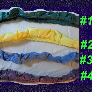 May include: Four different colors of fabric trim, labeled #1 through #4. The trim is a ruffled, gathered style. The colors are teal, yellow, blue, and purple.
