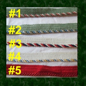 May include: Five decorative trim samples with different colors and textures. The trims are labeled with numbers from #1 to #5 in yellow. The trims include green, white, red, and blue colors. The trims are on a white background.