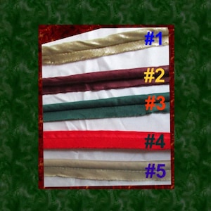 May include: Five different types of trim, labeled #1 through #5, are shown. The trim is folded in half and laid out on a white surface. The trim is in the following colors: gold, burgundy, green, red, and beige.