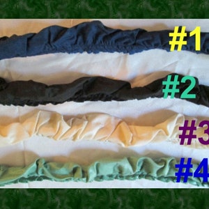 May include: Four fabric strips in different colors and textures, numbered 1 through 4. The strips are arranged horizontally, with the top strip being navy blue, the second black, the third cream, and the bottom green.