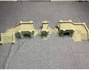 May include: Three pieces of a ruined stone bridge model, painted in a muted green color. The bridge has a central archway and steps leading up to it.