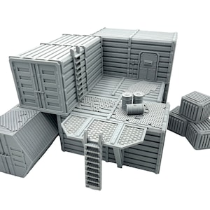 May include: A set of gray plastic modular building pieces for a tabletop game or diorama. The set includes a large building with a door, a ladder, and a platform, as well as several smaller boxes and barrels.