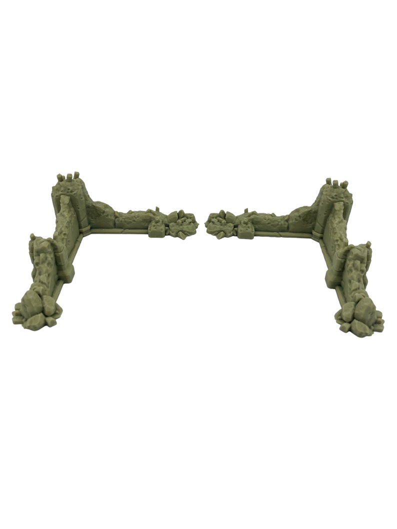 May include: Two L-shaped miniature terrain wall sections in a light olive green color. Each piece features a textured, weathered stone surface with jagged edges, rubble piles at the base, and vertical pillar supports at the corners.
