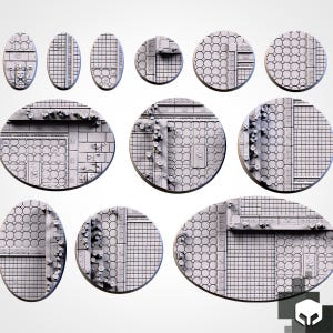 May include: A collection of eleven gray miniature bases in various circular and oval shapes. Each base features a detailed textured surface with geometric patterns, including square grids, hexagonal tiles, and decorative architectural elements.