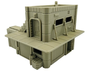 May include: A tan-colored, 3D-printed miniature building with a futuristic, industrial design. The structure features multiple levels, a door, windows, and a slatted walkway. The building has a detailed, textured surface and is likely for tabletop gaming or model building.