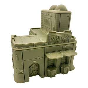 May include: A monochromatic light olive green 3D printed miniature building structure featuring a flat roof, a central raised section with two dome-like tops, a front entrance with a geometric door, two small awnings, and stylized text on the facade.
