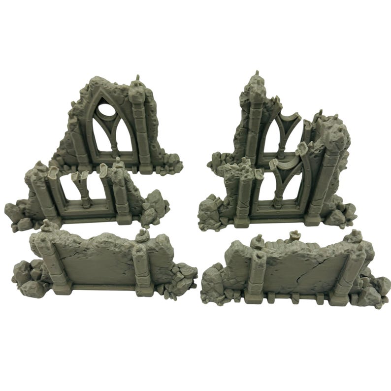 May include: Four gray miniature ruined structures, likely for tabletop gaming or model building. The pieces include sections of arched windows and crumbling walls, with a weathered, stone-like texture. The pieces are arranged on a white background.