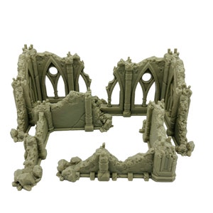 May include: A light gray, unpainted miniature terrain piece depicting the ruins of a stone building. The structure features jagged, broken walls, remnants of gothic-style arched windows with circular openings, and textured rubble details.