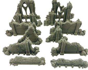May include: A collection of gray miniature ruined structures, likely for tabletop gaming or model building. The pieces include sections of walls, arches, and architectural details, all with a weathered, damaged appearance. The set appears to be made of a durable material.