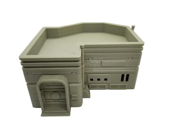 May include: A light gray, 3D-printed model of a building with a flat roof and detailed architectural features. The model has a rectangular shape with a door, windows, and vents. The building is made of a solid, opaque material.