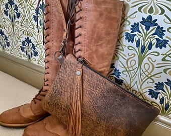 Bolso de mano de piel color canela desgastada con borla hecha a mano