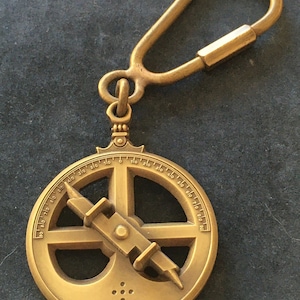 Beautiful antique and rare bronze key chain with small astrolabe Aveiro from navy museum