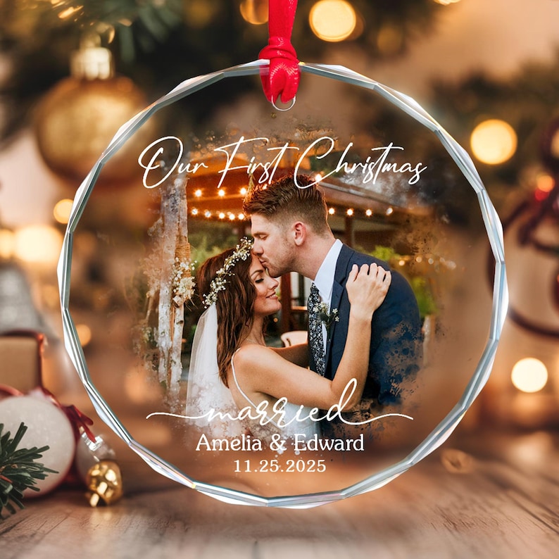 May include: A clear, round Christmas ornament with a photo of a couple kissing. The ornament has the text "Our First Christmas" and "married" with the names Amelia & Edward and the date 11.25.2025.