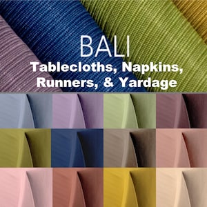 May include: The image showcases a variety of fabric swatches in shades of blue, green, and purple. The word "BALI" is displayed above the text "Tablecloths, Napkins, Runners, & Yardage", indicating the product category. Below, a grid of fabric samples in various colors is presented.