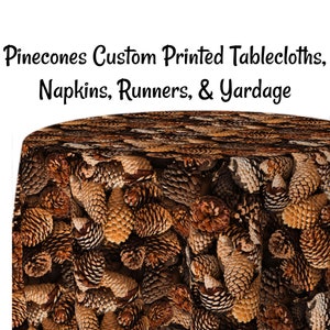 May include: A round tablecloth with a brown and tan pine cone pattern. The tablecloth is made of fabric and is suitable for use as a table covering.  Pinecones Custom Printed Tablecloths, Napkins, Runners, & Yardage