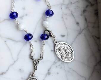 Blue and White glass bead 9 day novena tracker. Includes clip for tracking novena days. Features Miraculous Medal and St Joseph medal