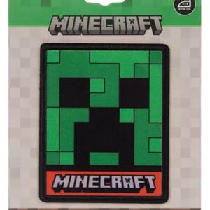 May include: An iron-on Minecraft patch featuring the iconic Creeper face in green and black pixelated design. The patch is rectangular with a black border and the Minecraft logo at the top and bottom. The packaging is green and white.