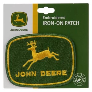 May include: Embroidered iron-on patch featuring the John Deere logo. The patch has a green background with a gold deer emblem and the words "JOHN DEERE" in gold. The patch is rectangular with rounded corners.