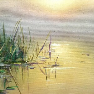 May include: A painting of a still pond with tall green reeds on the left side of the image. The water is a light yellow color and reflects the sky, which is a light blue and yellow color. The sun is shining brightly in the sky, and the water is calm and still.