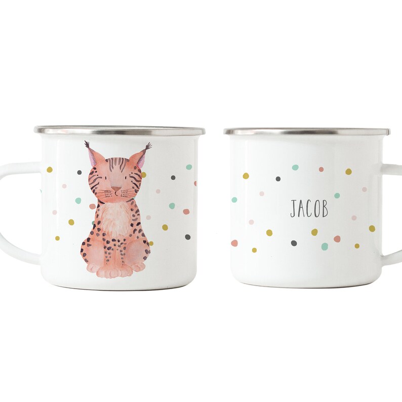 May include: Two white enamel mugs with a colourful confetti pattern. One mug features a watercolour illustration of a lynx. The other mug has the name "Jacob" written on it.