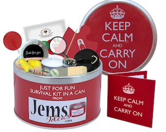 May include: A red metal survival kit in a can featuring the text Just For Fun Survival Kit In A Can From JemsIdeas.com. The open tin contains a red lollipop, a magnifying glass, a compass, a tea light, earplugs, a marble, and a safety pin.