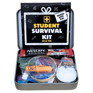May include: A silver metal tin containing a Student Survival Kit. The lid features a black sign with white text reading Student Survival Kit in a Tin and Packed with Fun. Inside are a Nescaf&eacute; coffee sachet, orange earplugs, and small items.