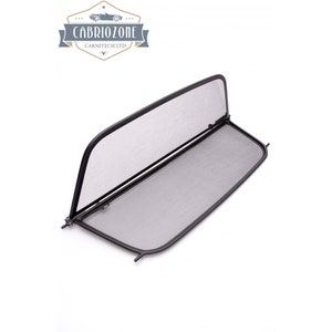 May include: Black mesh wind deflector for a convertible car. The deflector is folded in half and has a black metal frame.