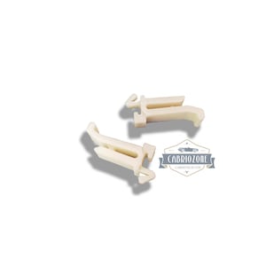 May include: Two off-white plastic clips, possibly car parts, are shown against a white backdrop. The clips have a distinctive shape with a hook-like design. The logo "CABRIOZONE CARNITECH LTD" is visible in the lower right corner.