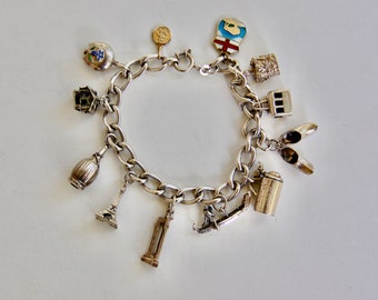 European Adventure Charm Bracelet, Curb Chain, Cowbell, Stein, Swiss, 800 Silver, Huguenin Freres, 10K YG Saint Christopher, 7.5", 42.10g