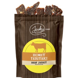 May include: A brown bag of Honey Teriyaki Beef Jerky with a yellow circle and a brown cow silhouette. The bag has a wood grain pattern and the word "Jerky.com" in white script.