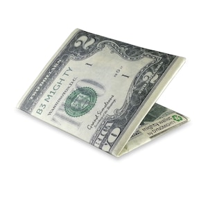 May include: A folded two dollar bill wallet, with the text "mighty wallet by DYNOMIGHTY" printed on the outside.