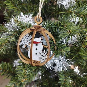 Snowman globe ornament laser cut wood.