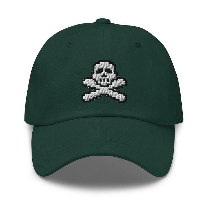 May include: A dark green baseball cap with a white embroidered skull and crossbones design.